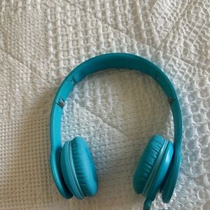 Turquoise Beats by Dre wired over the ear headphones